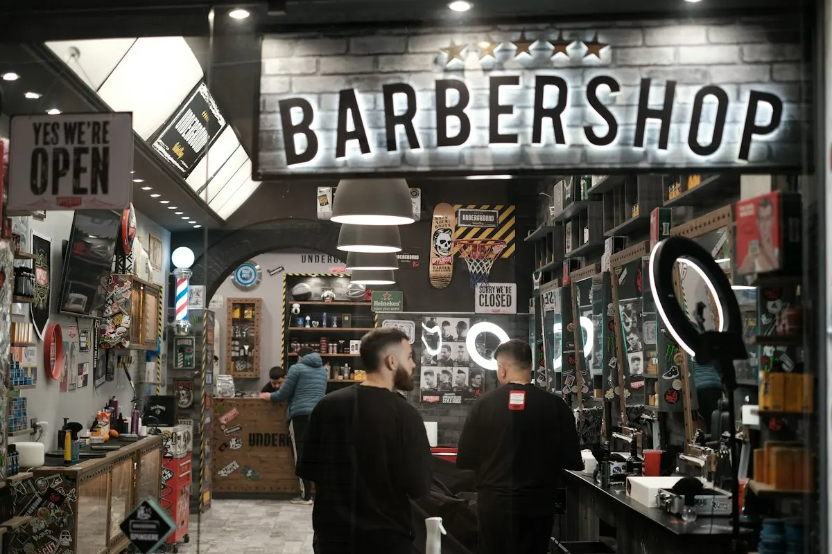 Busy barbershop floor with clients in chairs