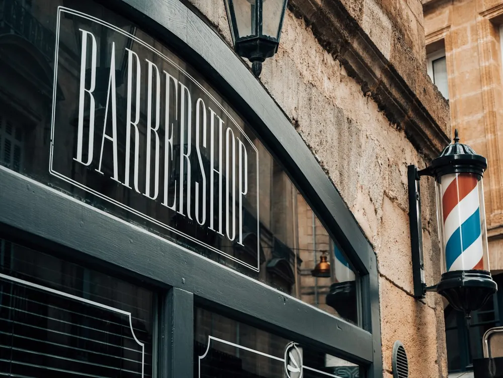 Barbershop storefront with a striped pole